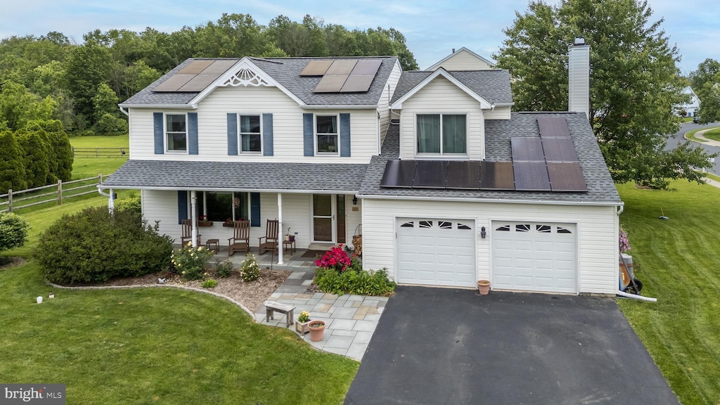 1051 Glen Manor Dr, Quakertown, PA 18951 - view of front of property with a porch, a shingled roof, solar panels, and driveway