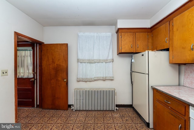 66 W Walnut Rd, Vineland, NJ 08360 - kitchen with radiator, brown cabinetry, freestanding refrigerator, and light countertops