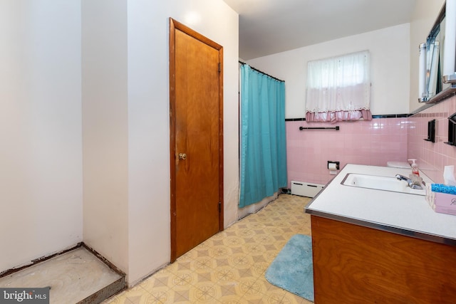 66 W Walnut Rd, Vineland, NJ 08360 - bathroom featuring baseboard heating, tile patterned floors, vanity, a shower with shower curtain, and tile walls