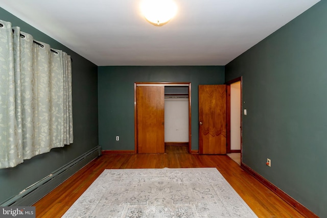 66 W Walnut Rd, Vineland, NJ 08360 - unfurnished bedroom featuring a baseboard heating unit, wood finished floors, and a closet
