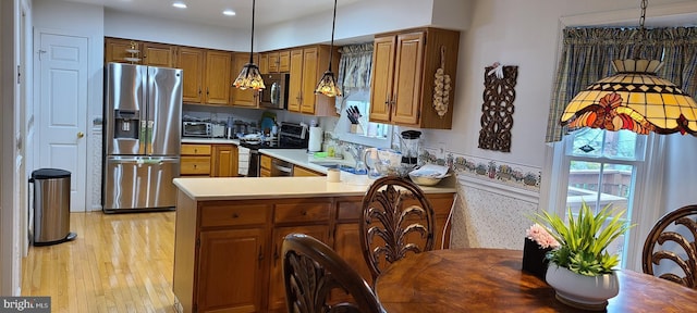 13209 Marthas Choice Cir, Bowie, MD 20720 - kitchen featuring stainless steel appliances, light countertops, recessed lighting, light wood-type flooring, and brown cabinetry