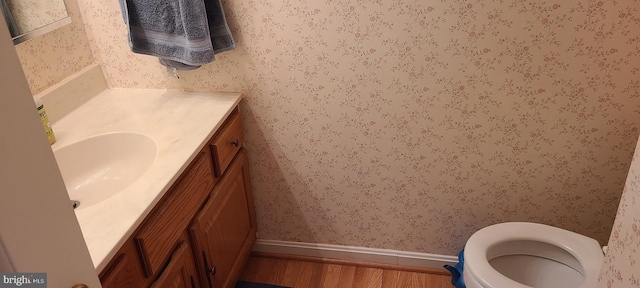 13209 Marthas Choice Cir, Bowie, MD 20720 - half bath featuring wallpapered walls, vanity, and wood finished floors