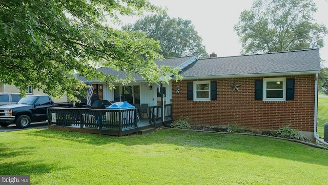 3483 Messersmith Rd, York, PA 17408 - rear view of house with a lawn, brick siding, roof with shingles, and a deck