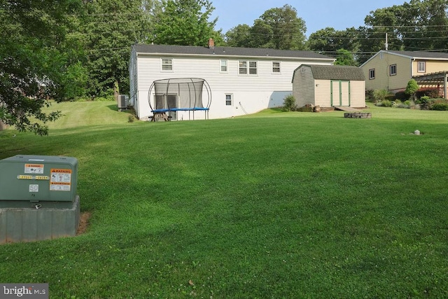 3483 Messersmith Rd, York, PA 17408 - rear view of property featuring a trampoline, a storage shed, and a lawn