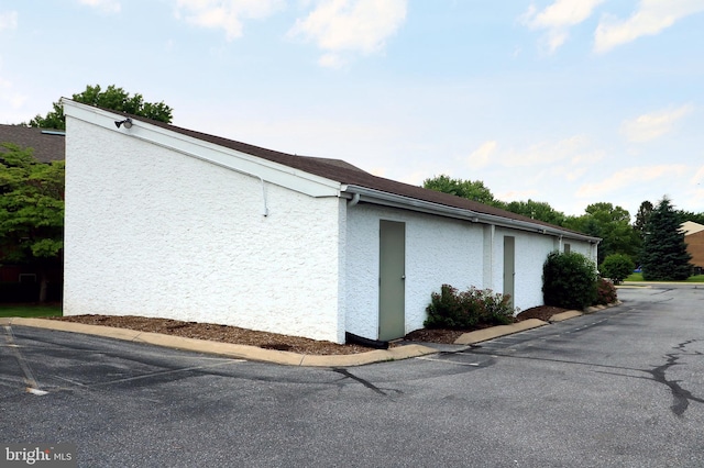 804 Stratford Dr Unit 11, State College, PA 16801 - view of side of property with stucco siding and uncovered parking