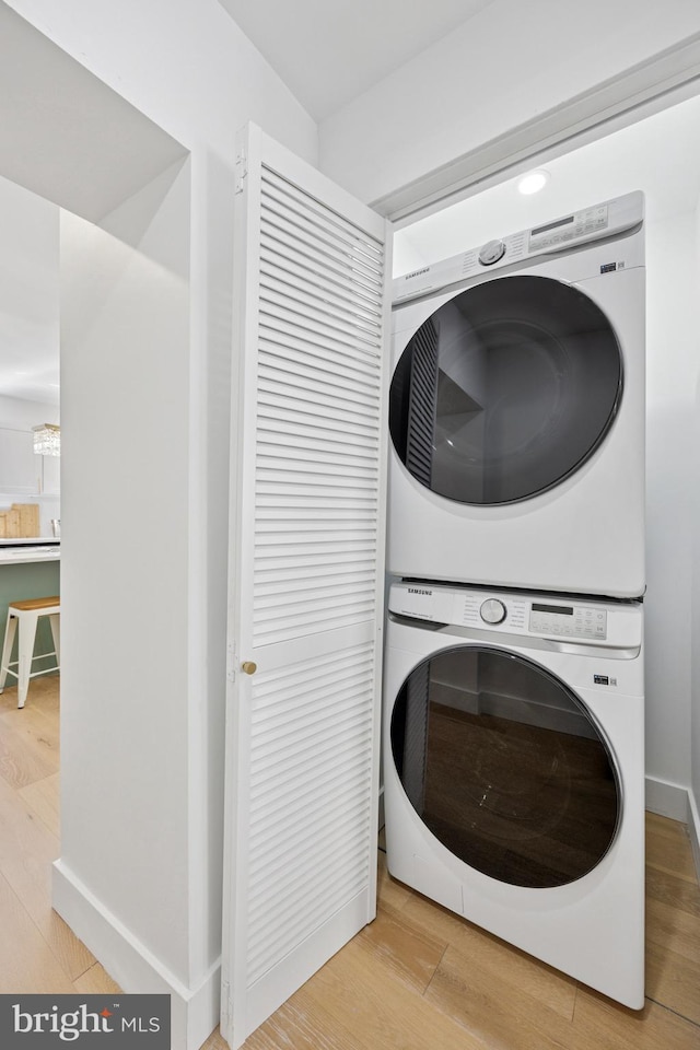 1232 S Bucknell St, Philadelphia, PA 19146 - washroom featuring estacked washer and dryer and wood finished floors