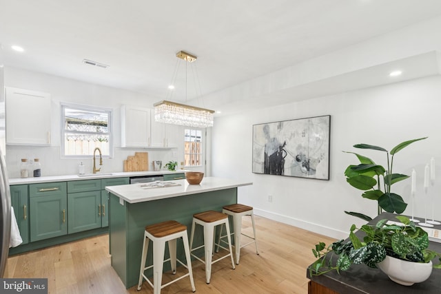 1232 S Bucknell St, Philadelphia, PA 19146 - kitchen with green cabinetry, light countertops, plenty of natural light, a breakfast bar, and recessed lighting
