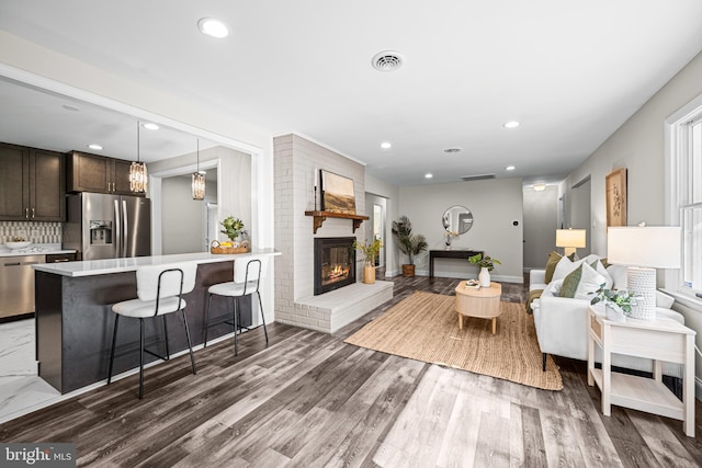 9017 Marcella Ave, Randallstown, MD 21133 - living area with recessed lighting, a fireplace, and wood finished floors