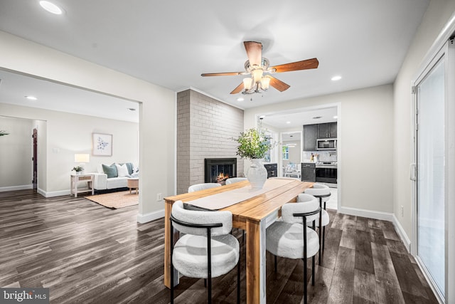 9017 Marcella Ave, Randallstown, MD 21133 - dining room featuring dark wood-style flooring, a fireplace, ceiling fan, and recessed lighting