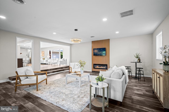 9017 Marcella Ave, Randallstown, MD 21133 - living area featuring dark wood-style flooring, healthy amount of natural light, a fireplace, and recessed lighting
