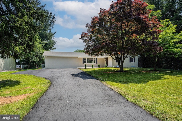 9017 Marcella Ave, Randallstown, MD 21133 - view of front of property featuring driveway, a front yard, and stucco siding