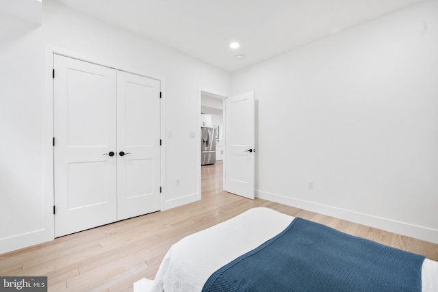 7214 16th Ave, Takoma Park, MD 20912 - bedroom featuring light wood finished floors, stainless steel fridge with ice dispenser, recessed lighting, and a closet