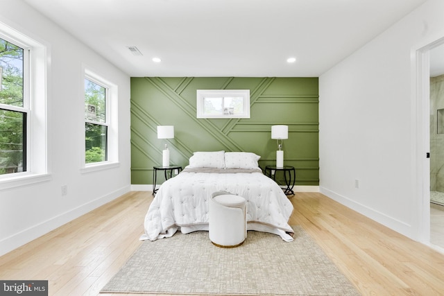 7214 16th Ave, Takoma Park, MD 20912 - bedroom with wood finished floors, a decorative wall, and recessed lighting