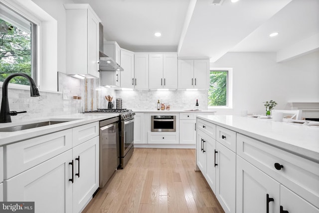 7214 16th Ave, Takoma Park, MD 20912 - kitchen featuring stainless steel dishwasher, light countertops, white cabinets, backsplash, and recessed lighting