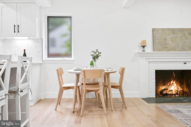 7214 16th Ave, Takoma Park, MD 20912 - dining space featuring light wood-type flooring and a brick fireplace