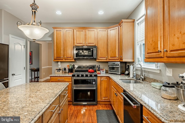 15 Boraten Cir, Royersford, PA 19468 - kitchen featuring range with two ovens, dishwashing machine, light wood-style flooring, light stone countertops, and pendant lighting