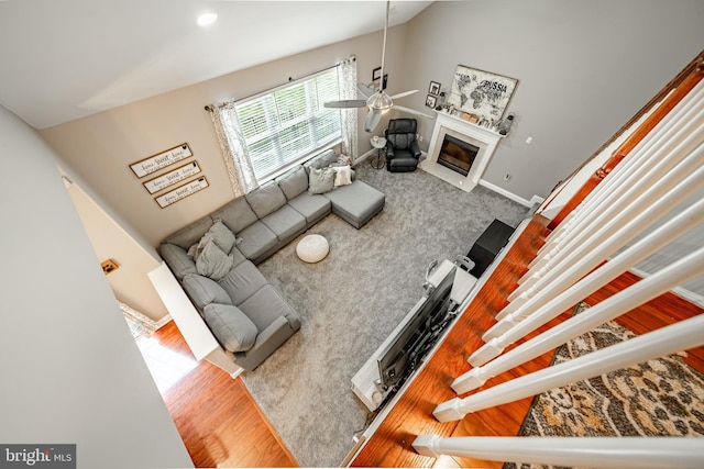 15 Boraten Cir, Royersford, PA 19468 - carpeted living room featuring a ceiling fan, a glass covered fireplace, and wood finished floors