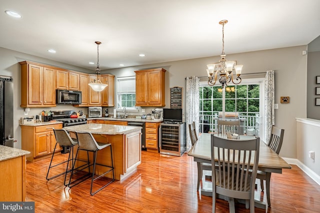 15 Boraten Cir, Royersford, PA 19468 - kitchen featuring black microwave, wine cooler, light wood-style flooring, stainless steel stove, and a chandelier