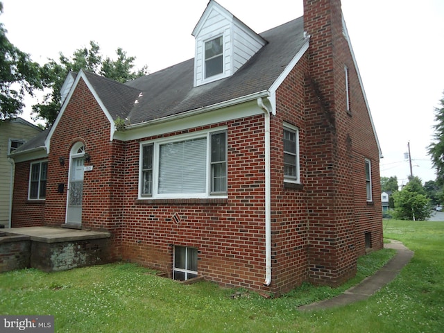 1501 Dixon St, Fredericksburg, VA 22401 - view of home's exterior featuring brick siding, a lawn, a chimney, and a shingled roof