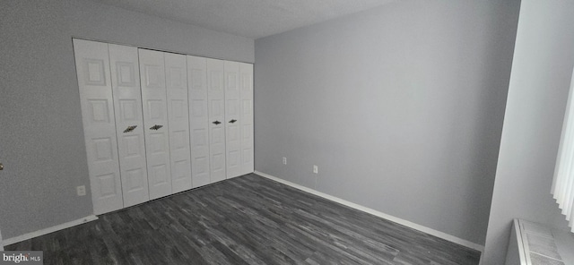 6100 Westchester Park Dr Unit 520, College Park, MD 20740 - unfurnished bedroom featuring dark wood-type flooring and a closet