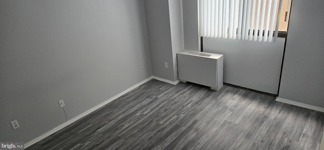 6100 Westchester Park Dr Unit 520, College Park, MD 20740 - unfurnished room featuring radiator heating unit and dark wood-style floors