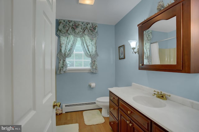 11733 Woodlea Dr, Waynesboro, PA 17268 - full bath with a baseboard heating unit, vanity, wood finished floors, and a shower with curtain
