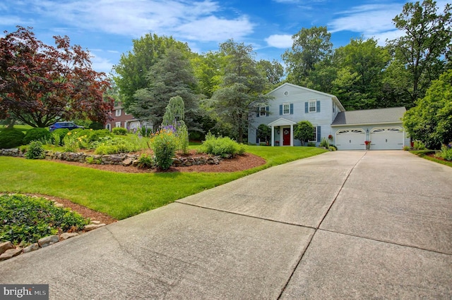 11733 Woodlea Dr, Waynesboro, PA 17268 - view of front of house with concrete driveway, a front lawn, and a garage