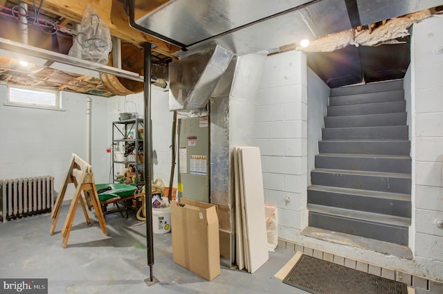 11733 Woodlea Dr, Waynesboro, PA 17268 - below grade area with radiator heating unit, stairs, and concrete block wall