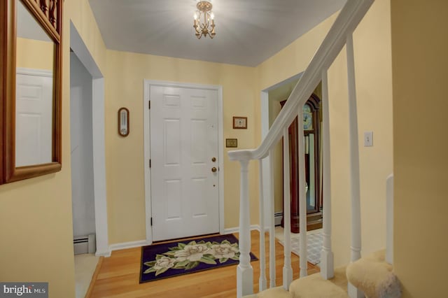 11733 Woodlea Dr, Waynesboro, PA 17268 - entryway featuring stairway, wood finished floors, baseboard heating, and a chandelier