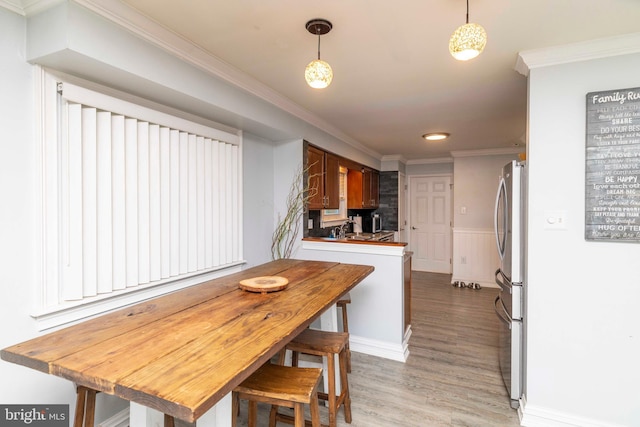 5960 Captain Milton E Major Ave, Bensalem, PA 19020 - kitchen featuring light wood-style flooring, ornamental molding, freestanding refrigerator, a wainscoted wall, and pendant lighting