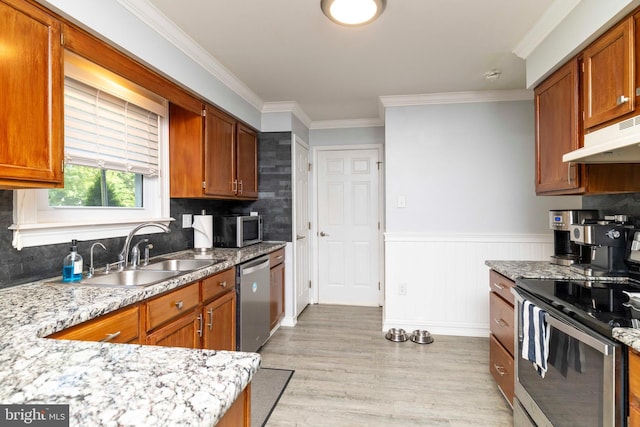 5960 Captain Milton E Major Ave, Bensalem, PA 19020 - kitchen with stainless steel appliances, under cabinet range hood, light wood-style flooring, crown molding, and tasteful backsplash