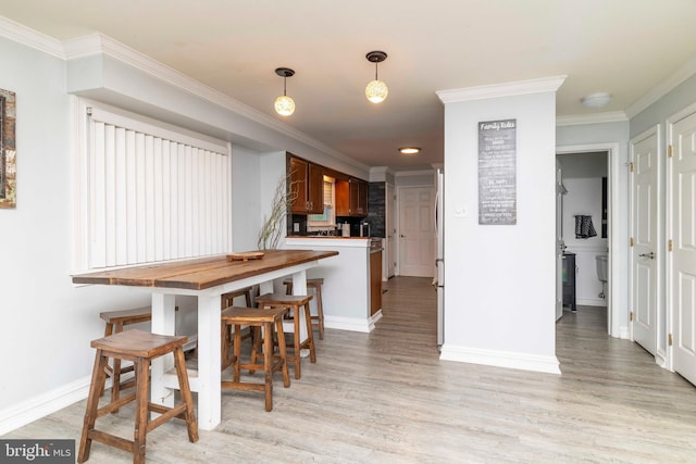 5960 Captain Milton E Major Ave, Bensalem, PA 19020 - kitchen featuring crown molding, light wood-style flooring, hanging light fixtures, and a peninsula