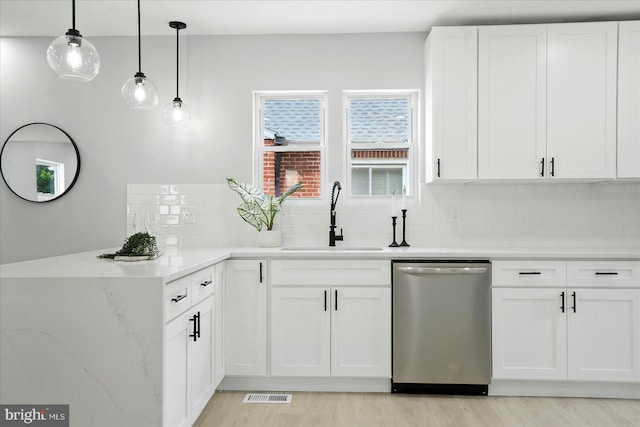 2011 Englewood Ave, Baltimore, MD 21207 - kitchen with dishwasher, decorative backsplash, white cabinets, and light wood-style floors