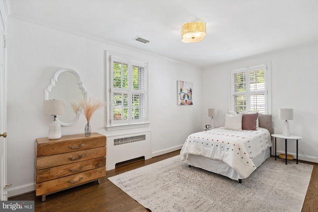 4731 Butterworth Pl NW, Washington, DC 20016 - bedroom featuring radiator heating unit, wood finished floors, and ornamental molding