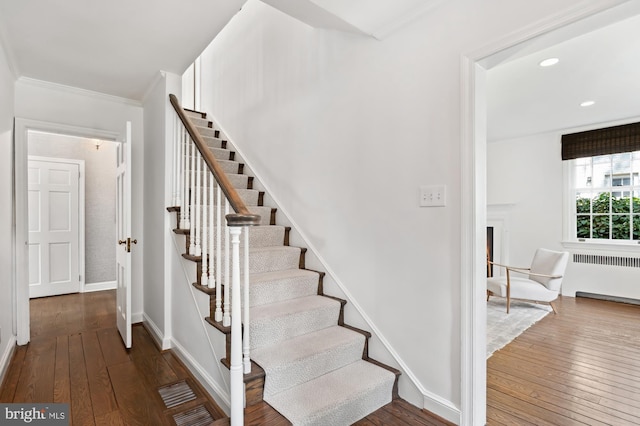 4731 Butterworth Pl NW, Washington, DC 20016 - staircase with radiator, wood-type flooring, ornamental molding, and recessed lighting