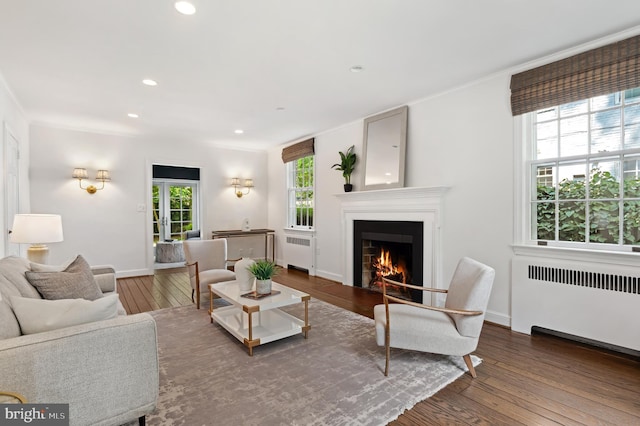 4731 Butterworth Pl NW, Washington, DC 20016 - living room with radiator, hardwood / wood-style floors, a warm lit fireplace, recessed lighting, and crown molding