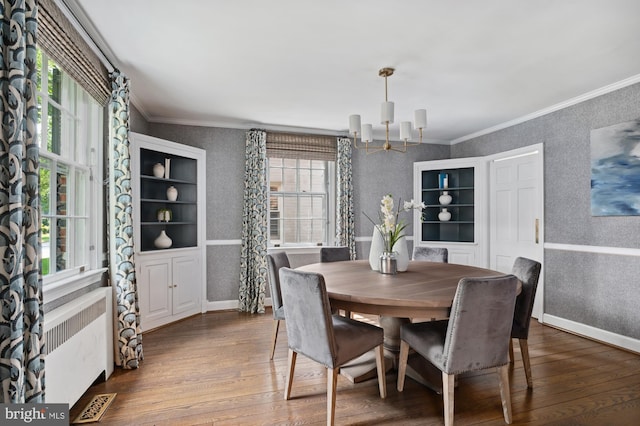 4731 Butterworth Pl NW, Washington, DC 20016 - dining space featuring a chandelier, radiator heating unit, dark wood-style flooring, ornamental molding, and wallpapered walls