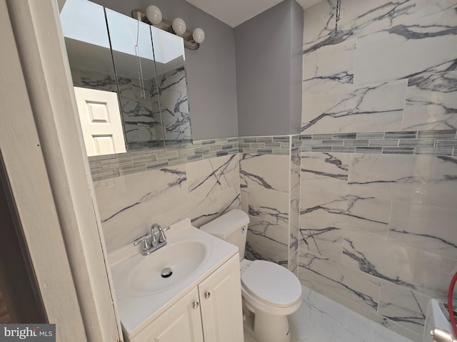 5903 Algon Ave, Philadelphia, PA 19149 - bathroom featuring marble finish floors, tile walls, and vanity