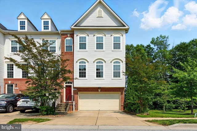 7003 Dannfield Ct, Glen Burnie, MD 21060 - townhome / multi-family property with brick siding, an attached garage, and concrete driveway