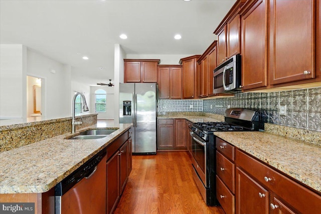 7003 Dannfield Ct, Glen Burnie, MD 21060 - kitchen with stainless steel appliances, dark wood-style flooring, light stone countertops, decorative backsplash, and recessed lighting