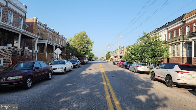 2618 E Biddle St, Baltimore, MD 21213 - view of asphalt road featuring street lighting, a residential view, and traffic signs