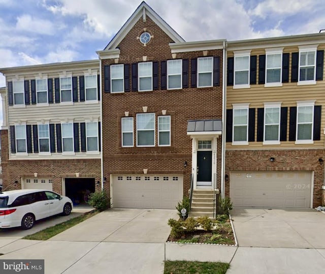 42510 Oak Park Sq, Ashburn, VA 20148 - townhome / multi-family property with a garage, driveway, and brick siding