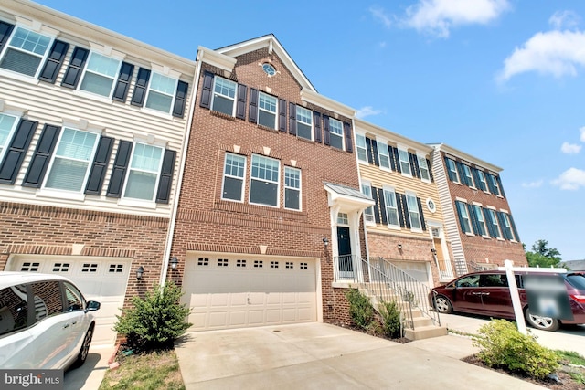 42510 Oak Park Sq, Ashburn, VA 20148 - townhome / multi-family property with an attached garage, concrete driveway, and brick siding