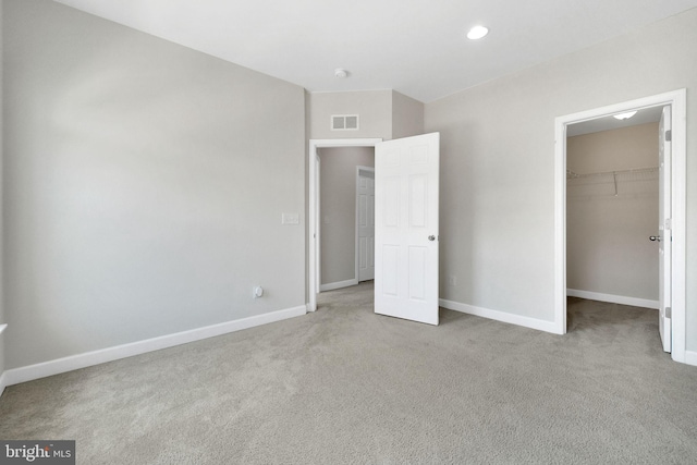 42510 Oak Park Sq, Ashburn, VA 20148 - unfurnished bedroom featuring carpet, a walk in closet, a closet, and recessed lighting