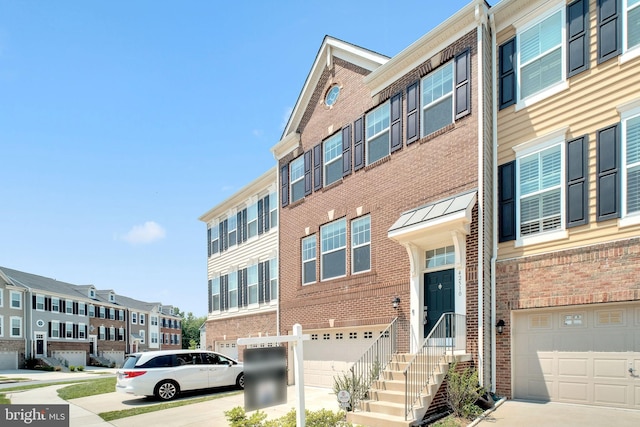 42510 Oak Park Sq, Ashburn, VA 20148 - view of front of property featuring a garage, brick siding, and concrete driveway
