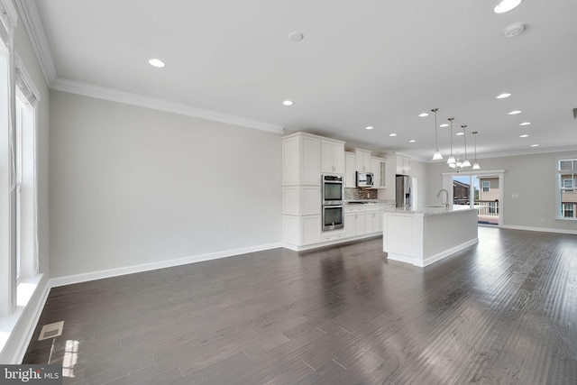 42510 Oak Park Sq, Ashburn, VA 20148 - unfurnished living room featuring recessed lighting, ornamental molding, and dark wood-type flooring