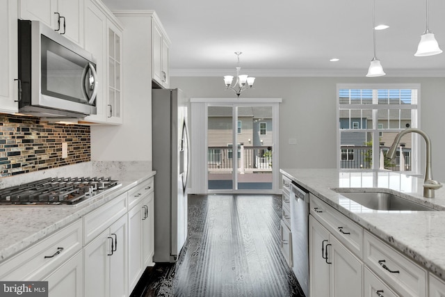 42510 Oak Park Sq, Ashburn, VA 20148 - kitchen featuring stainless steel appliances, ornamental molding, white cabinetry, healthy amount of natural light, and backsplash