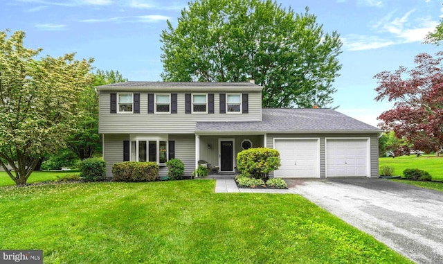 125 Christine Dr, Downingtown, PA 19335 - view of front of house featuring an attached garage, asphalt driveway, and a front yard