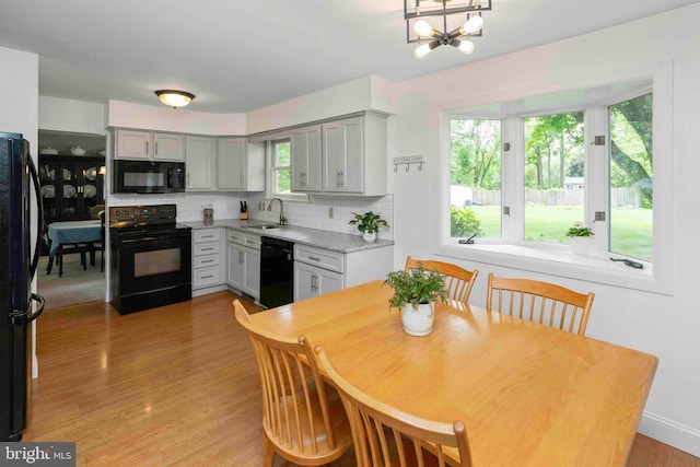 125 Christine Dr, Downingtown, PA 19335 - kitchen featuring black appliances, gray cabinets, decorative backsplash, and light wood-style flooring