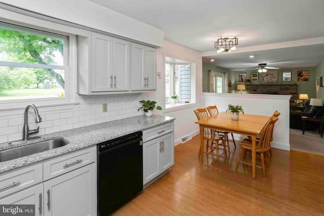 125 Christine Dr, Downingtown, PA 19335 - kitchen featuring black dishwasher, a ceiling fan, backsplash, light wood-style flooring, and plenty of natural light